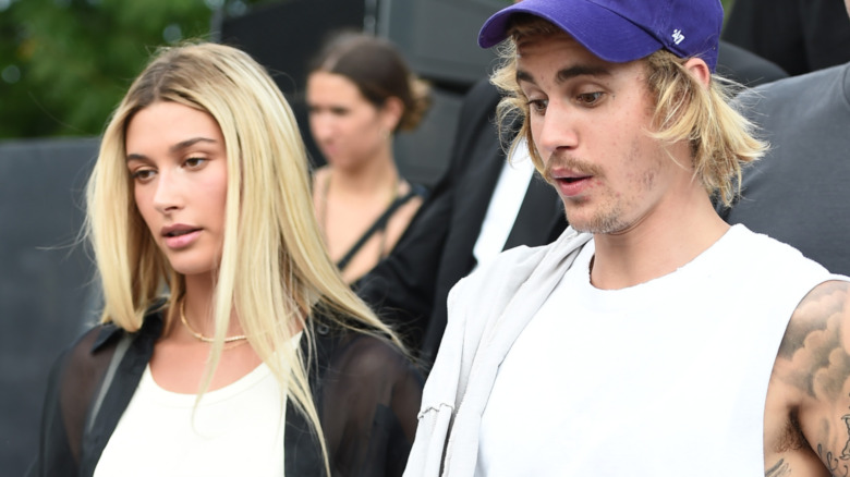 Hailey Baldwin and Justin Bieber walking outside 