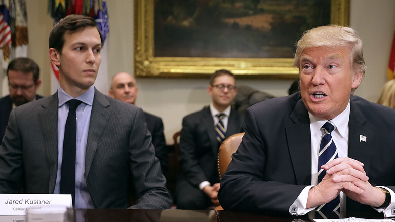 Jared Kushner and Donald Trump at an event, seated