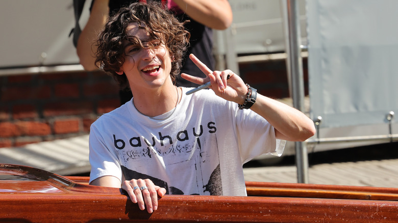 Timothée Chalamet putting up the peace sign