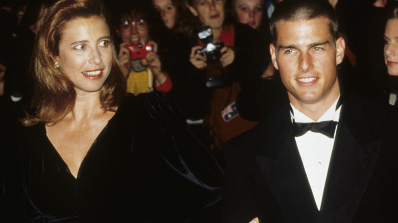 Mimi Rogers and Tom Cruise, posing arm in arm