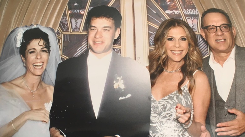 Rita Wilson and Tom Hanks posing with cutouts of them at their wedding