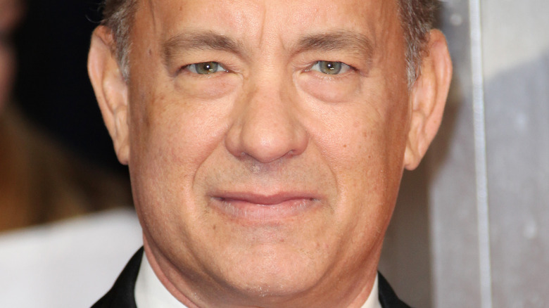 Tom Hanks smiles on red carpet