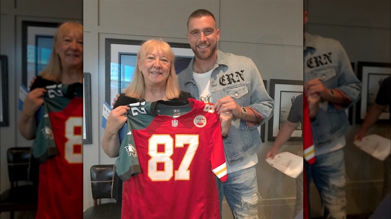 Donna and Travis Kelce smiling with a jersey