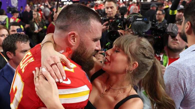 Travis Kelce and Taylor Swift hug each other