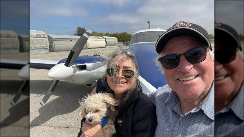 Treat Williams and wife Pam Van Sant in front of plane