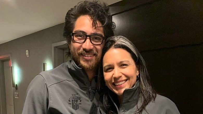 Tulsi Gabbard and Abraham Williams smiling in hallway