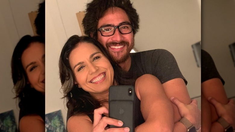 Tulsi Gabbard and Abraham Williams hugging in selfie