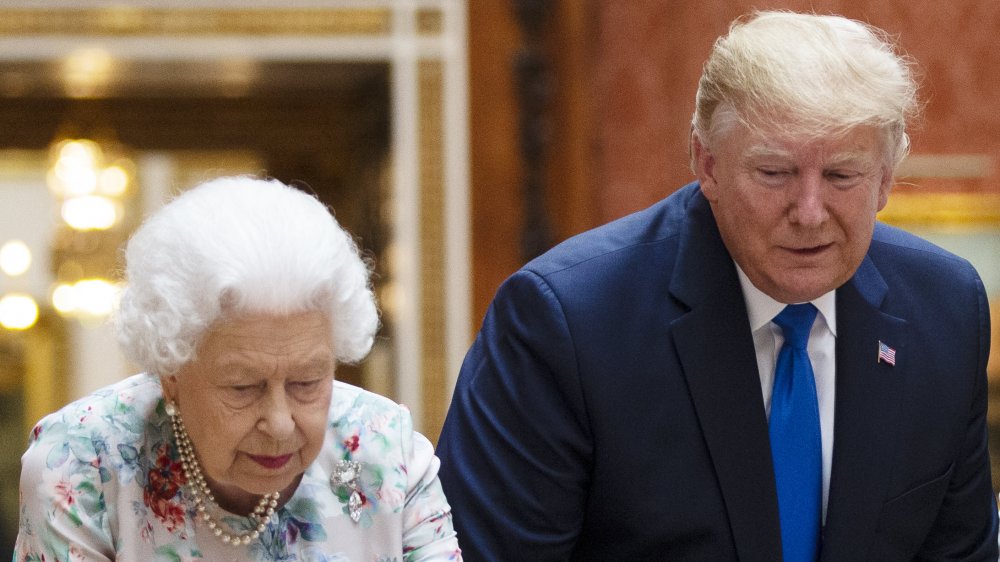 The queen and Trump looking down