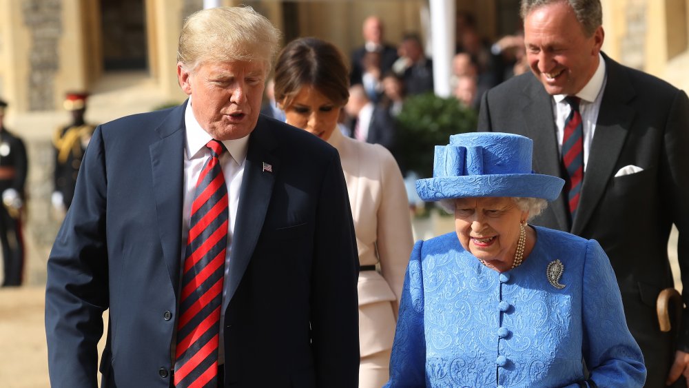 Donald Trump walking with the queen