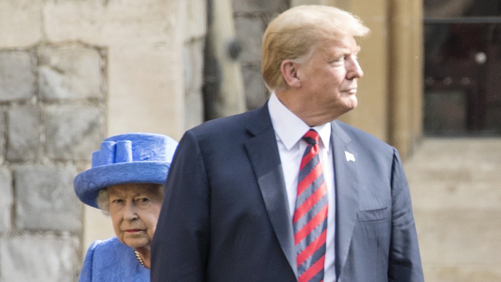 Trump walking in front of the queen