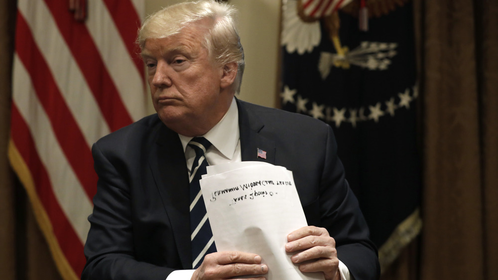 Donald Trump holding paper