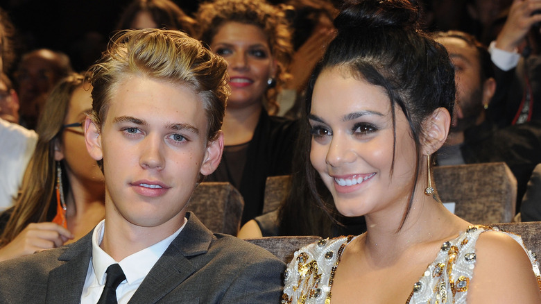 Austin Butler and Vanessa Hudgens sitting in an audience