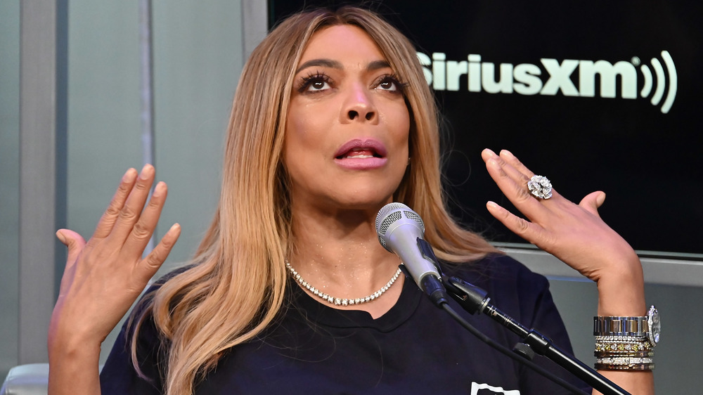 Wendy Williams with her hands up