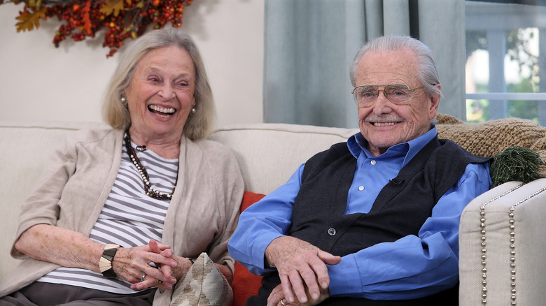 Bonnie Bartlett and William Daniels laughing on the couch