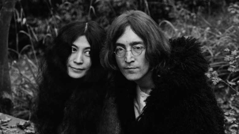 John Lennon and Yoko Ono standing together