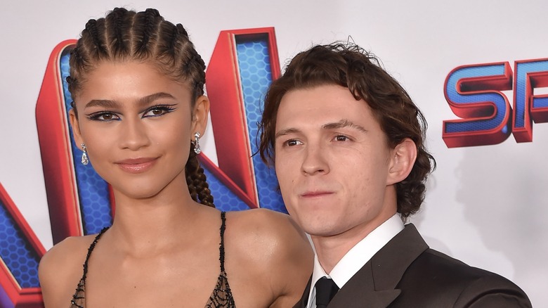 Zendaya and Tom Holland posing