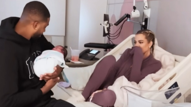 Khloé Kardashian and Tristan Thompson on hospital bed with son