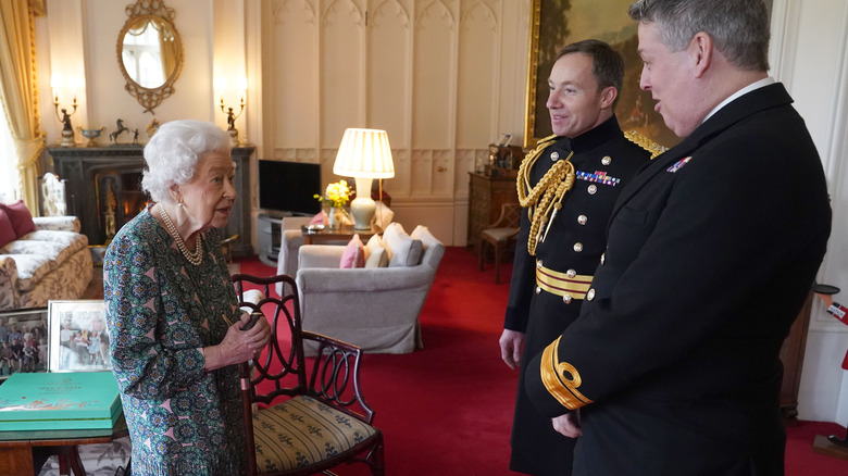 Queen Elizabeth II speaking with Rear Admiral James Macleod and Major General Eldon Millar 