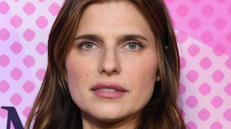 Lake Bell, wearing pink  in front of a pink background