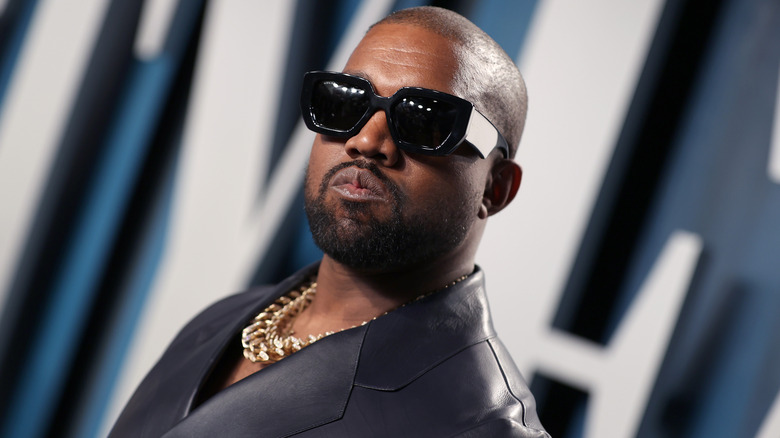 Kanye West posing with sunglasses on