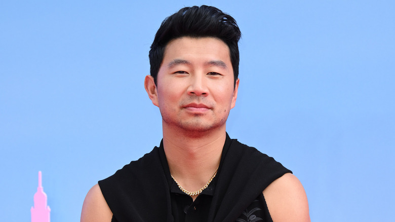 Simu Liu posing at the Barbie premiere 