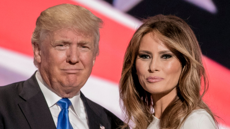 Donald and Melania Trump in front of American flag