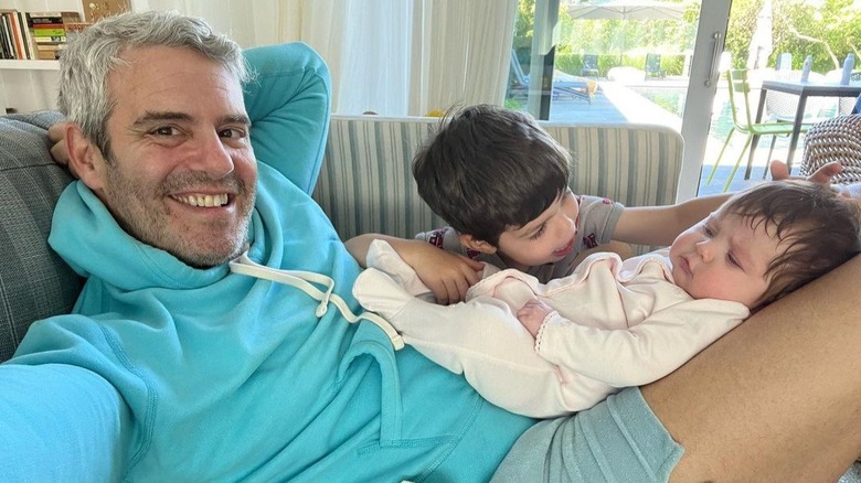 Andy Cohen poses happily with his children