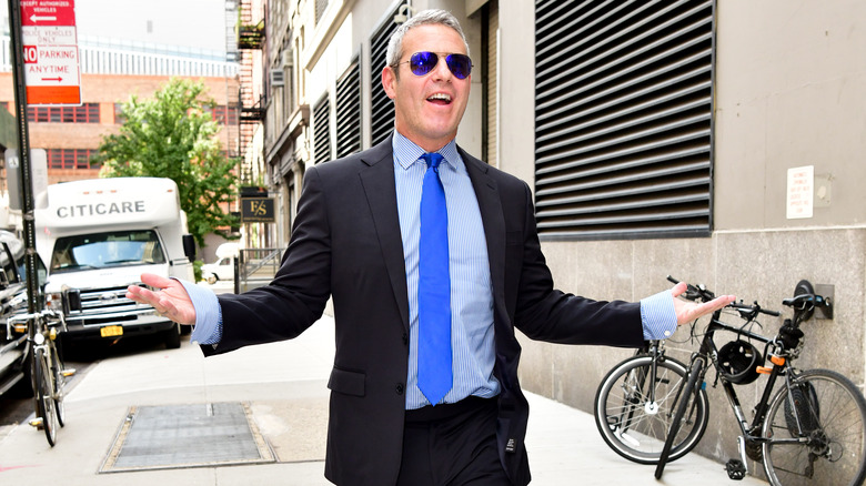 Andy Cohen walking animatedly