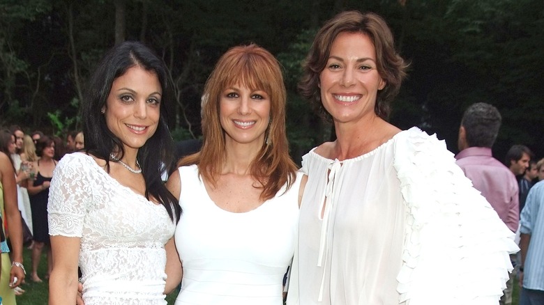 Bethenny Frankel, Jill Zarin, and Luann de Lesseps smiling and posing for photo