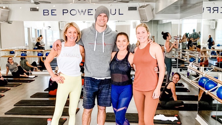 Greg Olsen and Kara Dooley pose at the gym