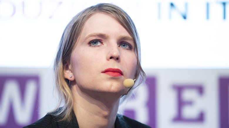 Chelsea Manning with red lipstick and a headset