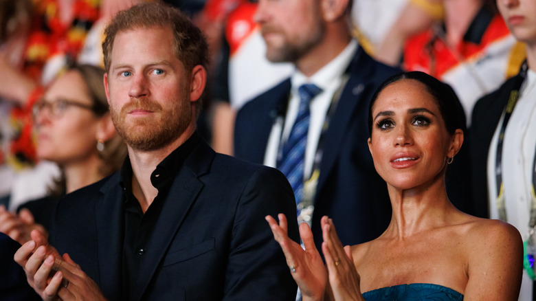 Prince Harry and Meghan Markle clapping