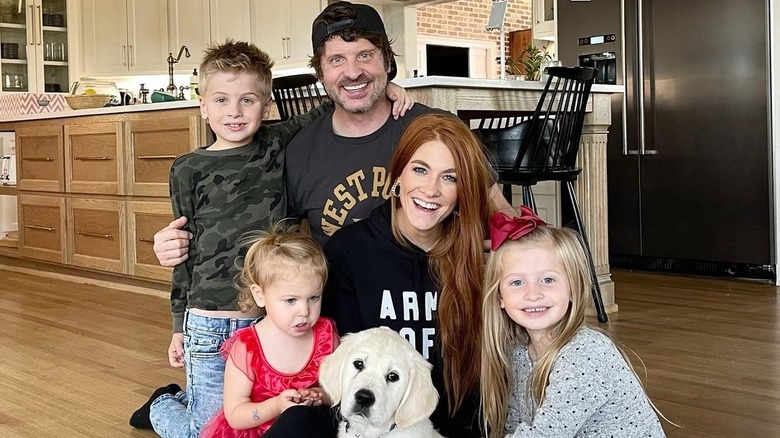 Jenn Todryk posing with family on floor