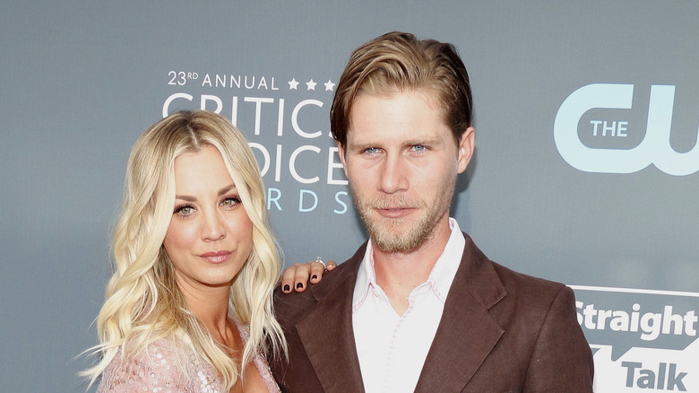 Karl Cook and Kaley Cuoco hugging on red carpet