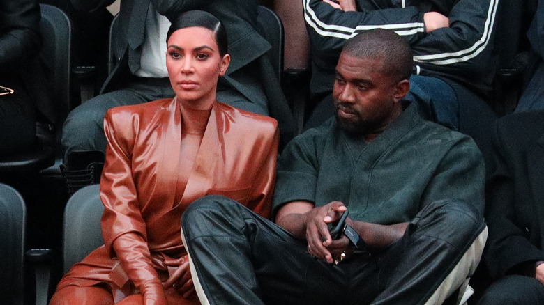 Kim Kardashian West and Kanye West posing court side