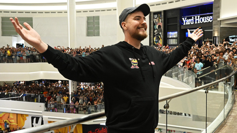 Mr Beast poses with crowd behind him