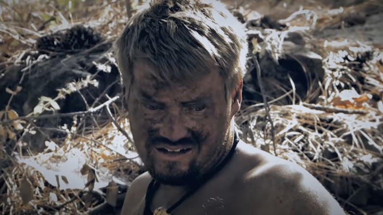 "Naked and Afraid" contestant grimacing