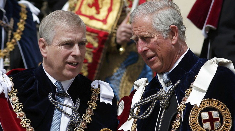 Prince Andrew and Prince Charles talk at an engagement