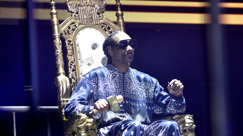 Snoop Dogg sitting on a throne