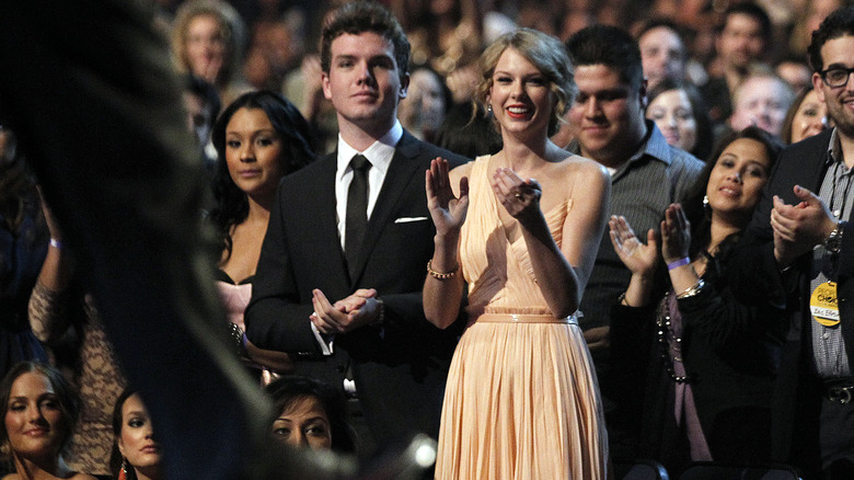 Austin and Taylor Swift giving standing ovation