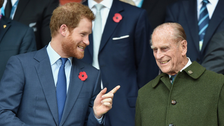 Prince Harry talking to Prince Philip