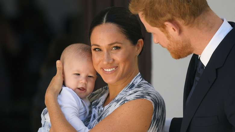 Prince Harry, Duke of Sussex and Meghan, Duchess of Sussex caring for their baby son Archie Mountbatten-Windsor