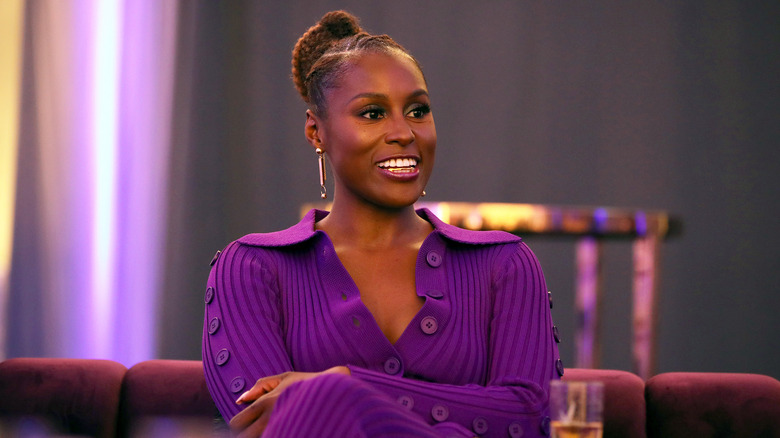 Issa Rae laughing in purple