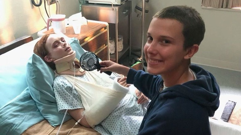 Millie Bobby Brown smiling, Sadie Sink in hospital bed