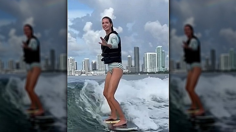 Ivanka Trump surfing in a striped swimsuit