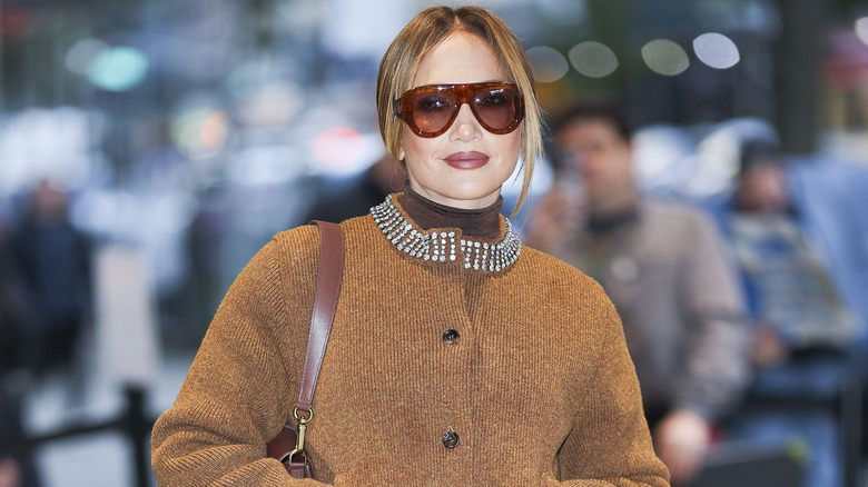 Jennifer Lopez posing in a Gucci knit set and oversized sunglasses