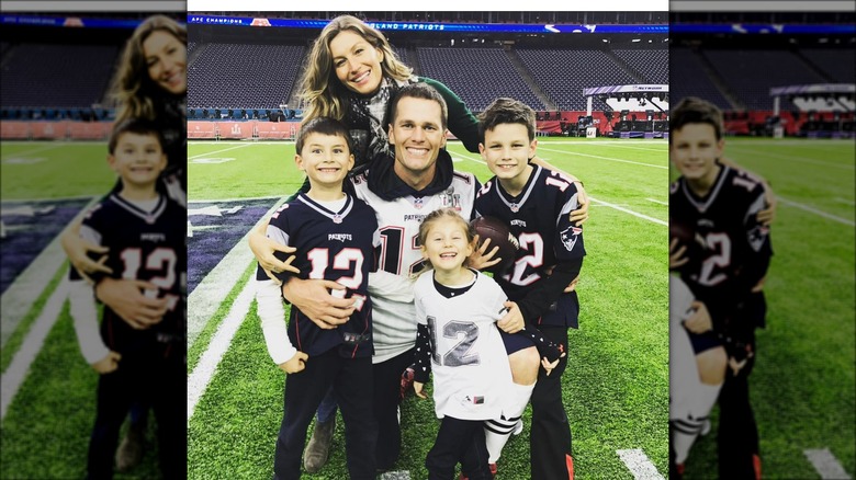 Tom Brady and family posing in football stadium