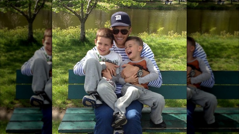 Tom Brady and sons sitting on bench