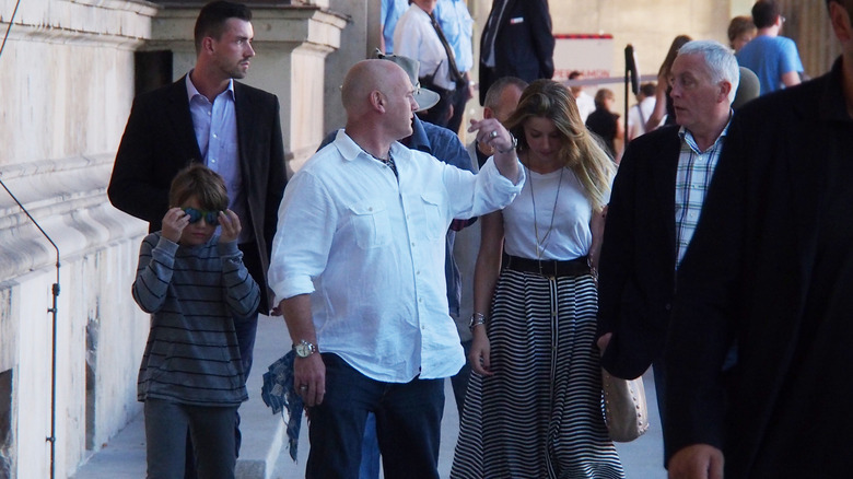 Jack Depp and Amber Heard outside a museum, flanked by security.