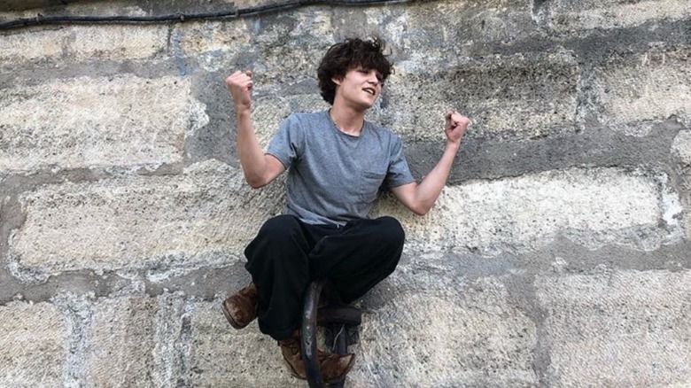 Jack Depp posing on a wall.